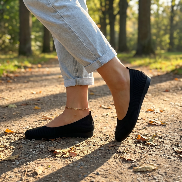 Black knit ballet flats on a park path